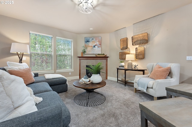 living room with a tile fireplace and carpet