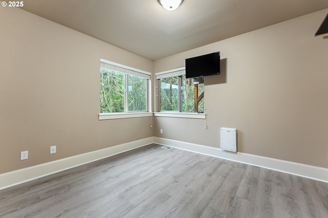 unfurnished room with light hardwood / wood-style floors