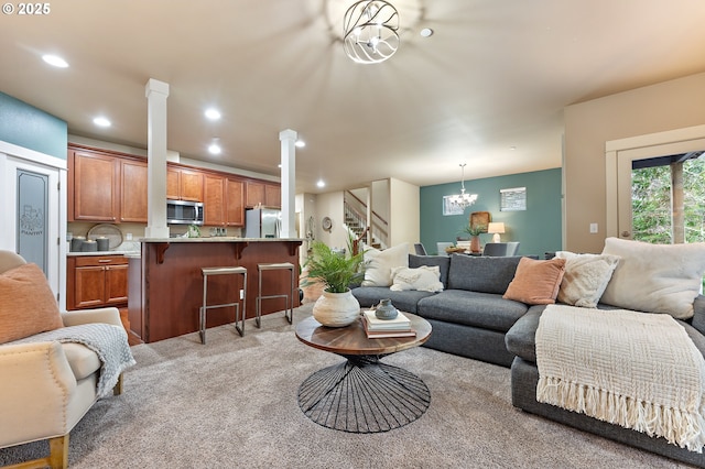 living room with light colored carpet and an inviting chandelier