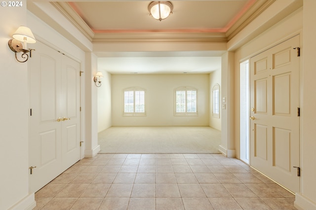 carpeted entryway with crown molding