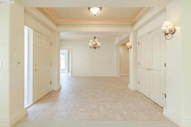 hall featuring an inviting chandelier, crown molding, and light tile patterned flooring