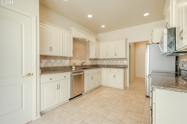 kitchen with white cabinets, dark stone countertops, and appliances with stainless steel finishes