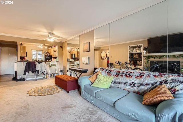 carpeted living room with ceiling fan, crown molding, and a tile fireplace