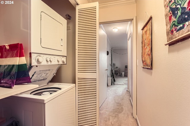 laundry room featuring light carpet, stacked washer and dryer, and ornamental molding