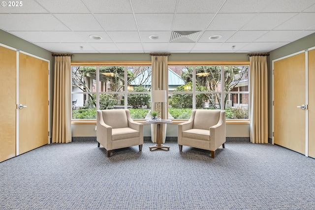 unfurnished room featuring a paneled ceiling and carpet flooring