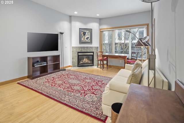 living room featuring wood-type flooring and a fireplace