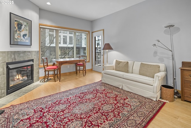 living room with hardwood / wood-style floors and a fireplace