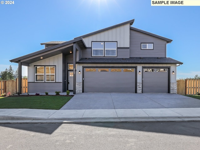 view of front of home with a front yard and a garage