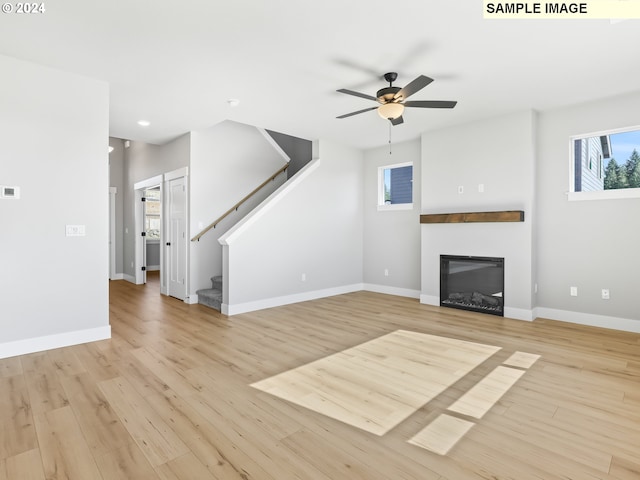 unfurnished living room featuring ceiling fan and light hardwood / wood-style flooring