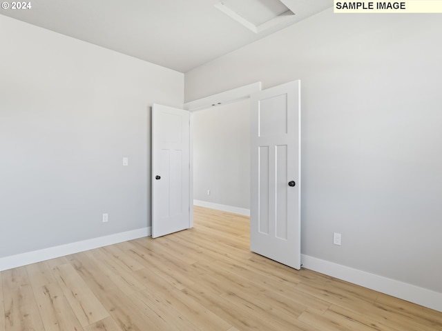 unfurnished room with light wood-type flooring