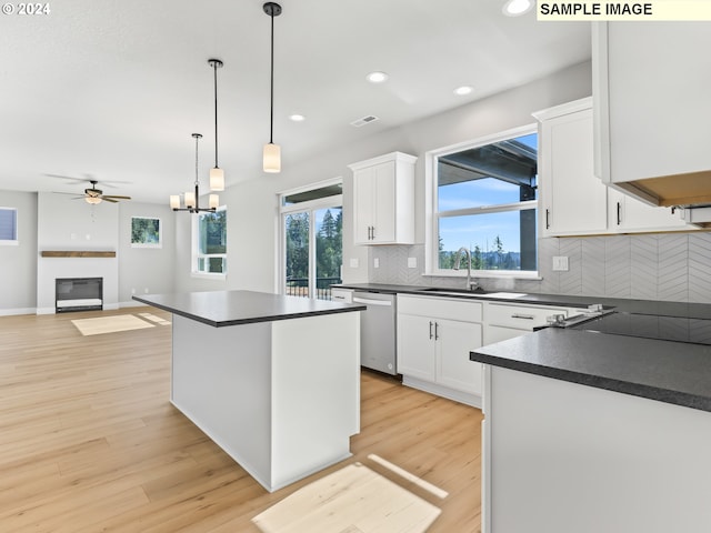 kitchen with white cabinetry, sink, and light wood-type flooring