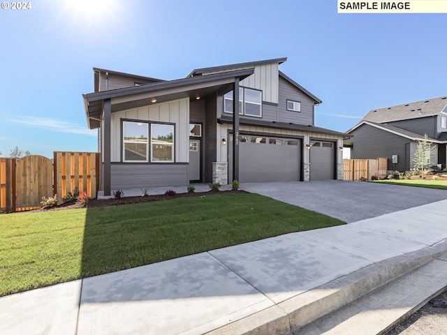 view of front of property with a front lawn and a garage