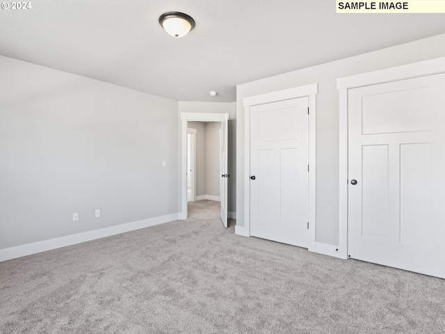 unfurnished bedroom with light carpet