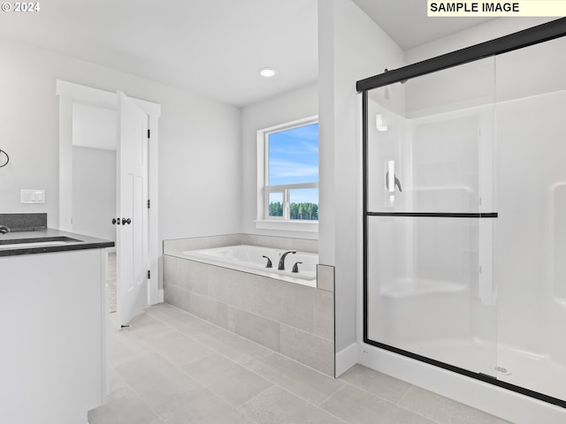 bathroom featuring tile patterned floors, vanity, and plus walk in shower