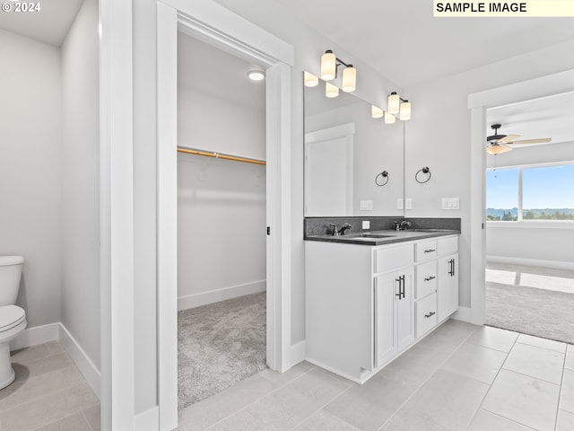 bathroom with tile patterned floors, ceiling fan, toilet, and vanity