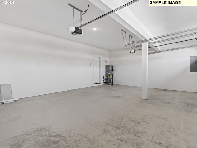 garage featuring strapped water heater, electric panel, and a garage door opener