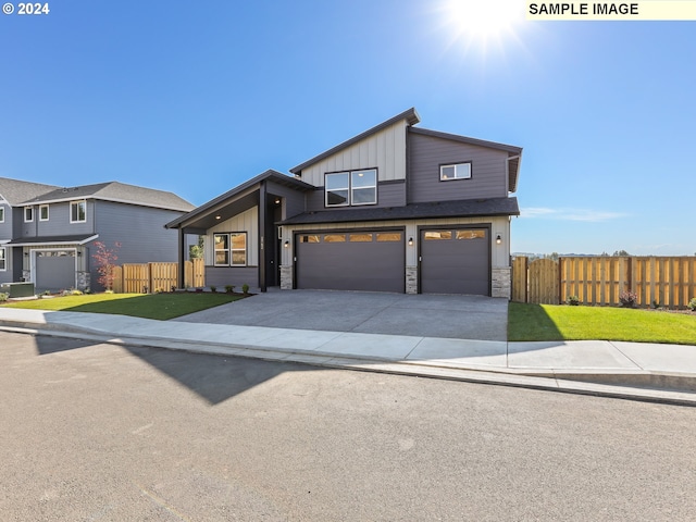 view of front of home with a garage and a front yard