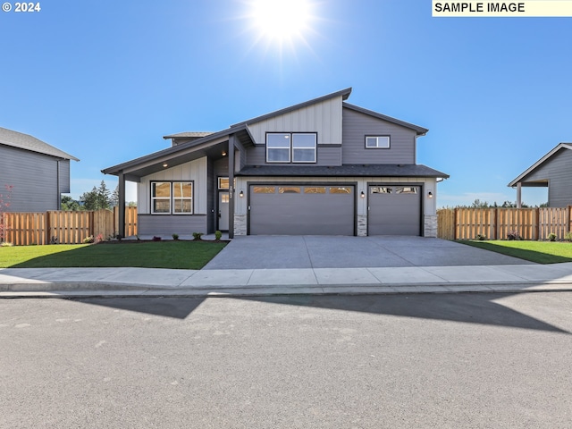 modern inspired farmhouse featuring a garage and a front lawn