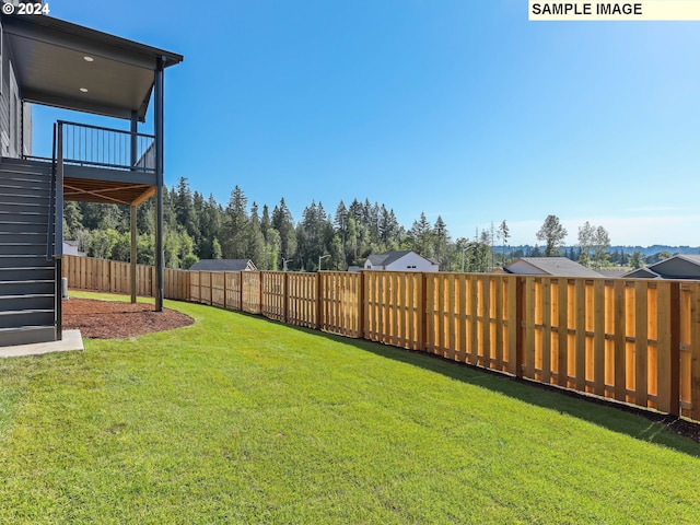 view of yard featuring a balcony