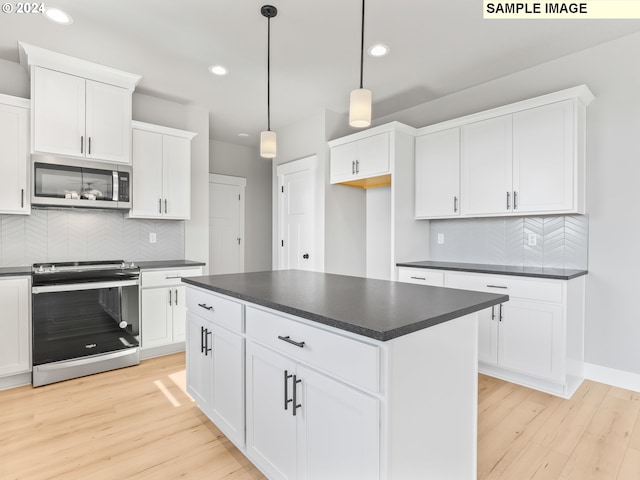 kitchen featuring pendant lighting, appliances with stainless steel finishes, tasteful backsplash, light hardwood / wood-style floors, and white cabinetry