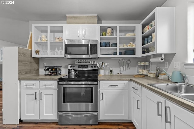 kitchen featuring dark hardwood / wood-style floors, sink, white cabinetry, and stainless steel appliances