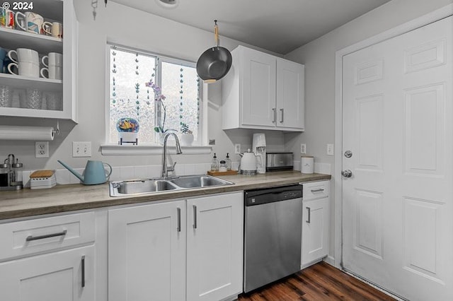 kitchen featuring dark hardwood / wood-style flooring, sink, white cabinets, and stainless steel dishwasher