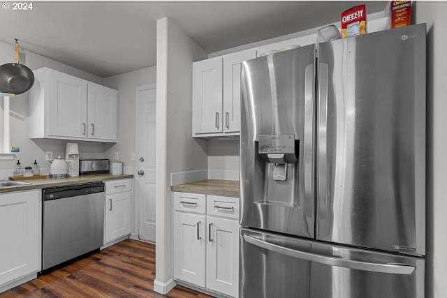 kitchen with dark hardwood / wood-style floors, wood counters, white cabinetry, and stainless steel appliances