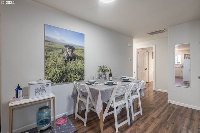 dining area featuring dark wood-type flooring