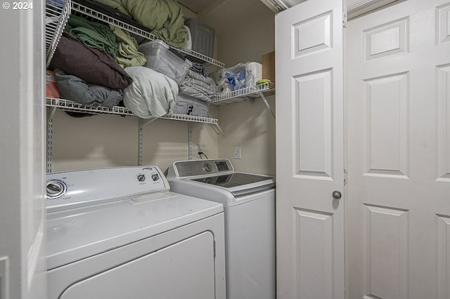 clothes washing area featuring separate washer and dryer