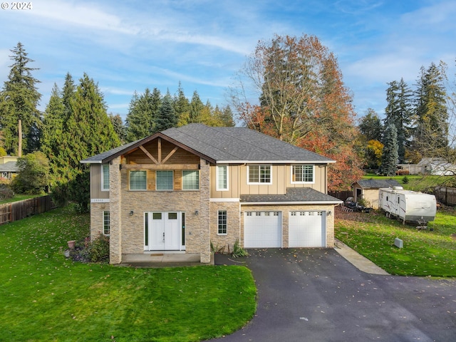 view of front property with a front yard and a garage