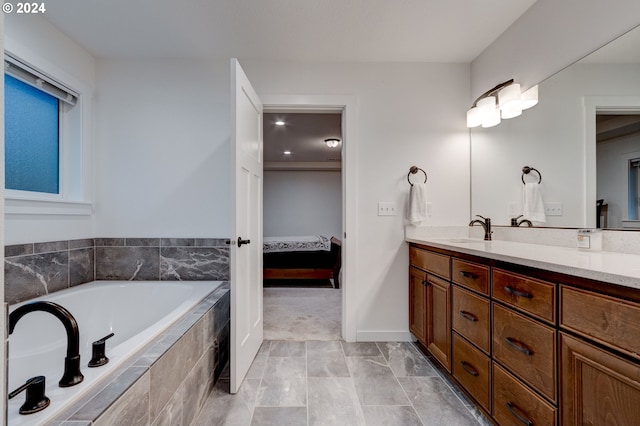 bathroom with vanity and tiled bath