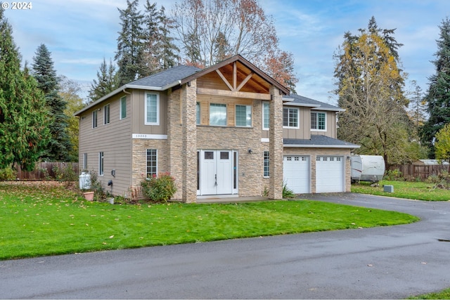 view of front facade with a front yard and a garage