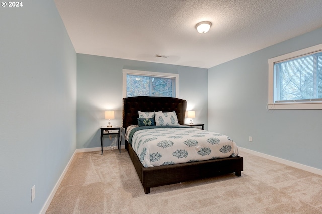 carpeted bedroom featuring a textured ceiling