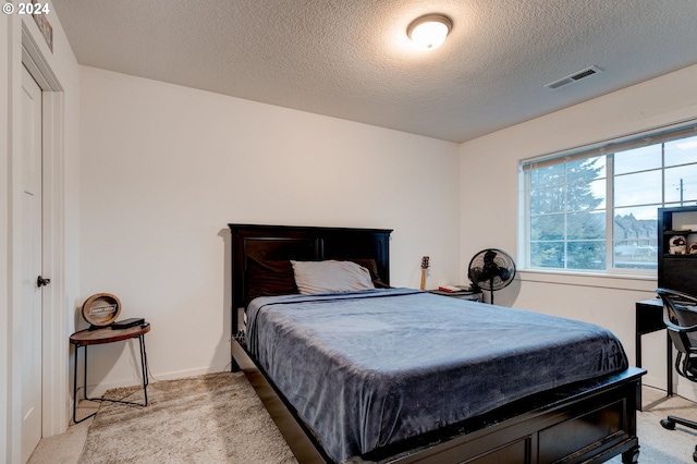 carpeted bedroom with a textured ceiling