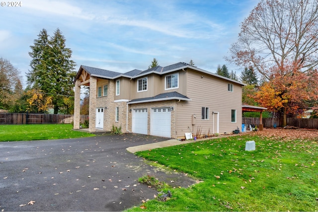 view of home's exterior featuring a garage and a yard