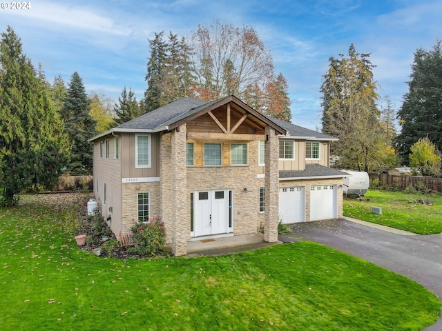 view of front of home featuring a front lawn and a garage