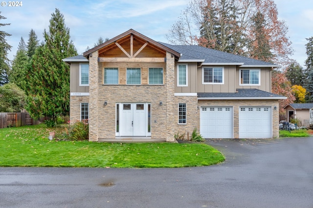 view of front of home featuring a front yard and a garage