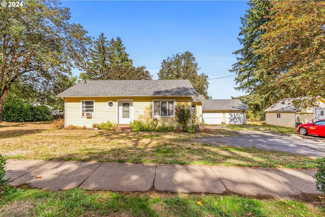 view of front of property with an outbuilding and a front yard