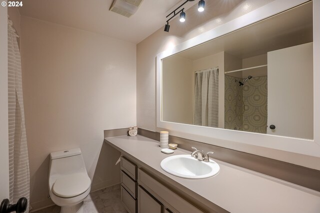 bathroom featuring vanity and toilet