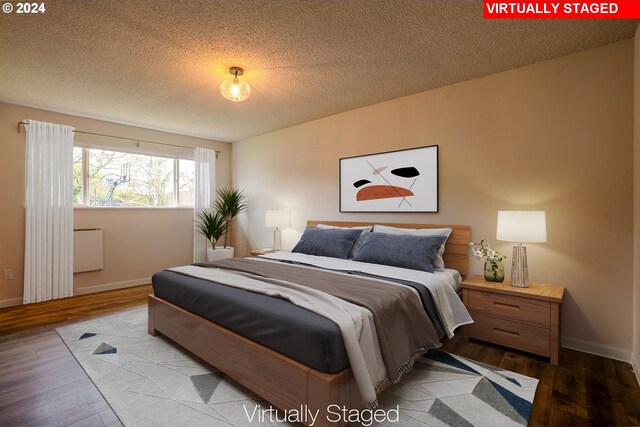 bedroom featuring light hardwood / wood-style flooring and a textured ceiling