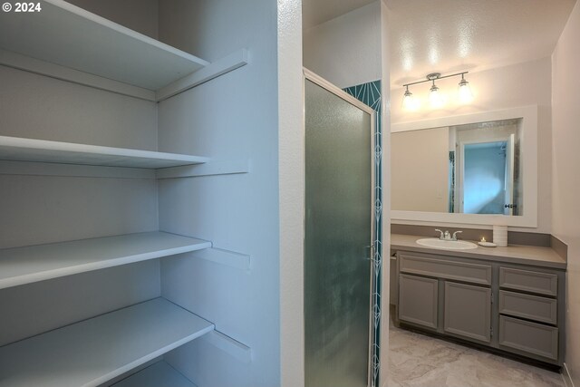 bathroom with vanity and an enclosed shower