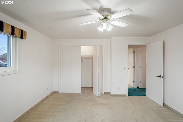 unfurnished bedroom featuring ceiling fan and light colored carpet