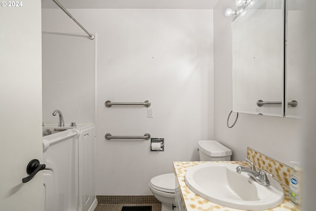 bathroom featuring tile patterned flooring, vanity, and toilet