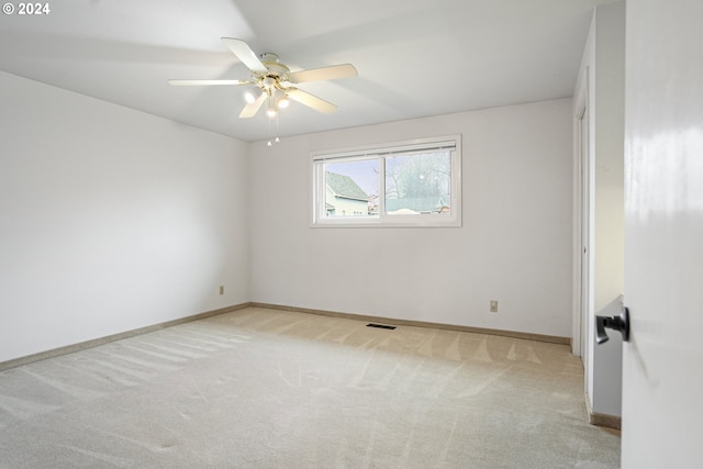 carpeted empty room with ceiling fan