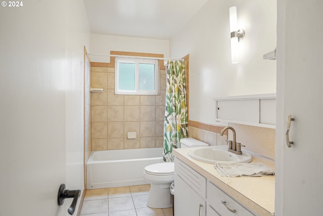 full bathroom featuring tile patterned flooring, vanity, toilet, and shower / bath combo with shower curtain