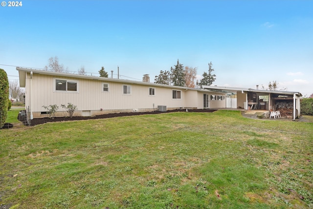 back of house with a yard and central AC unit