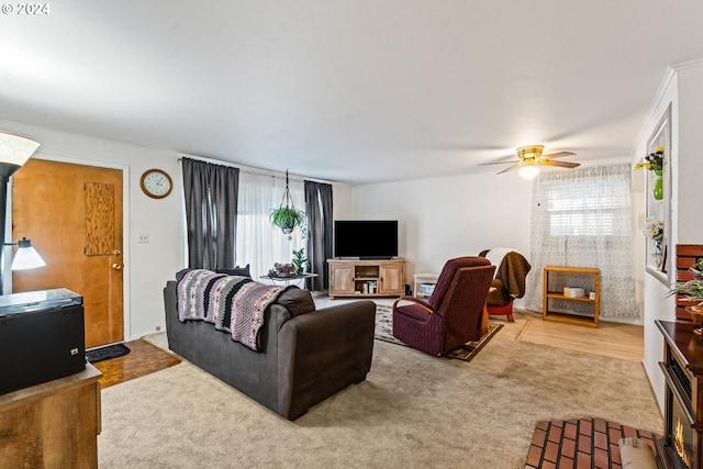 living room featuring crown molding, carpet floors, and ceiling fan