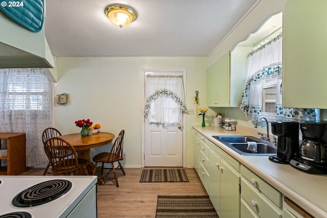 kitchen with white electric range, light hardwood / wood-style floors, sink, and green cabinetry