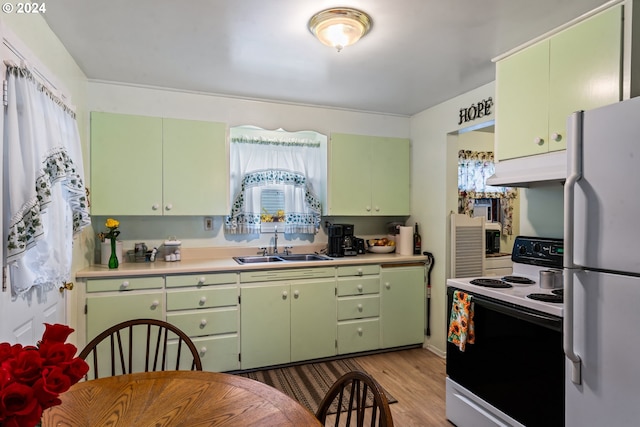 kitchen featuring light hardwood / wood-style floors, green cabinetry, sink, and white appliances