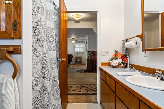 bathroom with vanity, crown molding, and tile patterned flooring